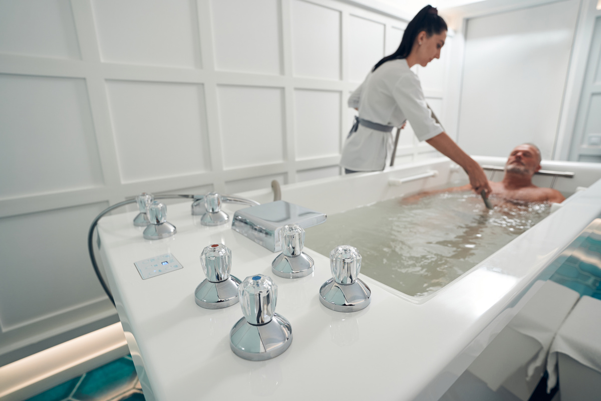 Man having hydrotherapy procedure at wellness center